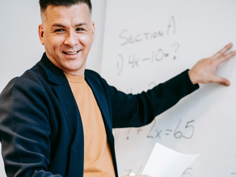 Instructor teaching at a whiteboard